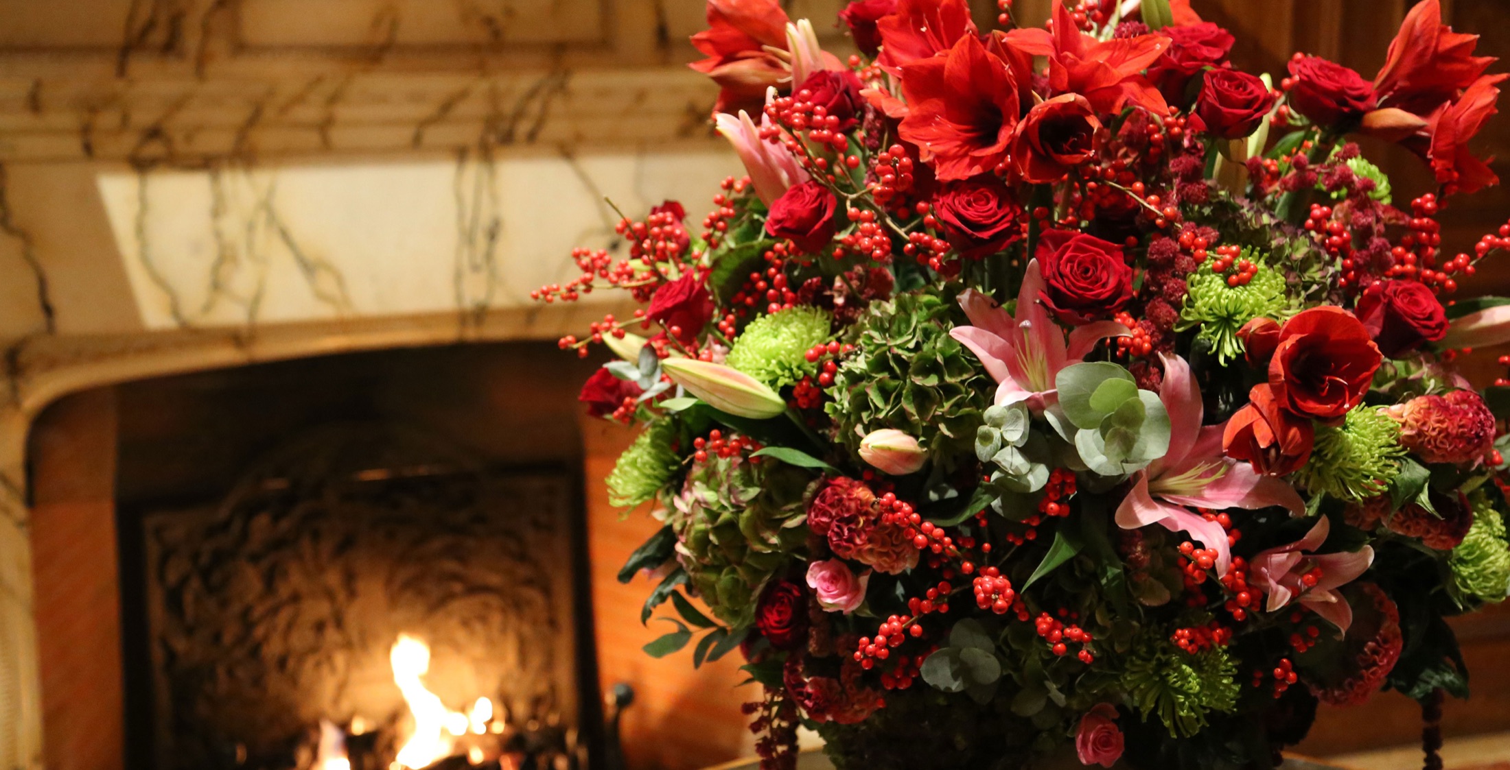 Red roses, lilies, berries and green hydrangea by Pascal Lavorel